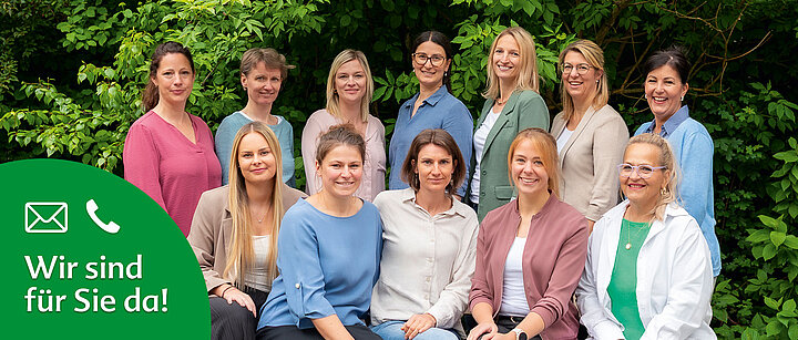 Eine Gruppe von Frauen mit unterschiedlichen Frisuren und Kleidungsstücken vor einer grünen Kulisse.